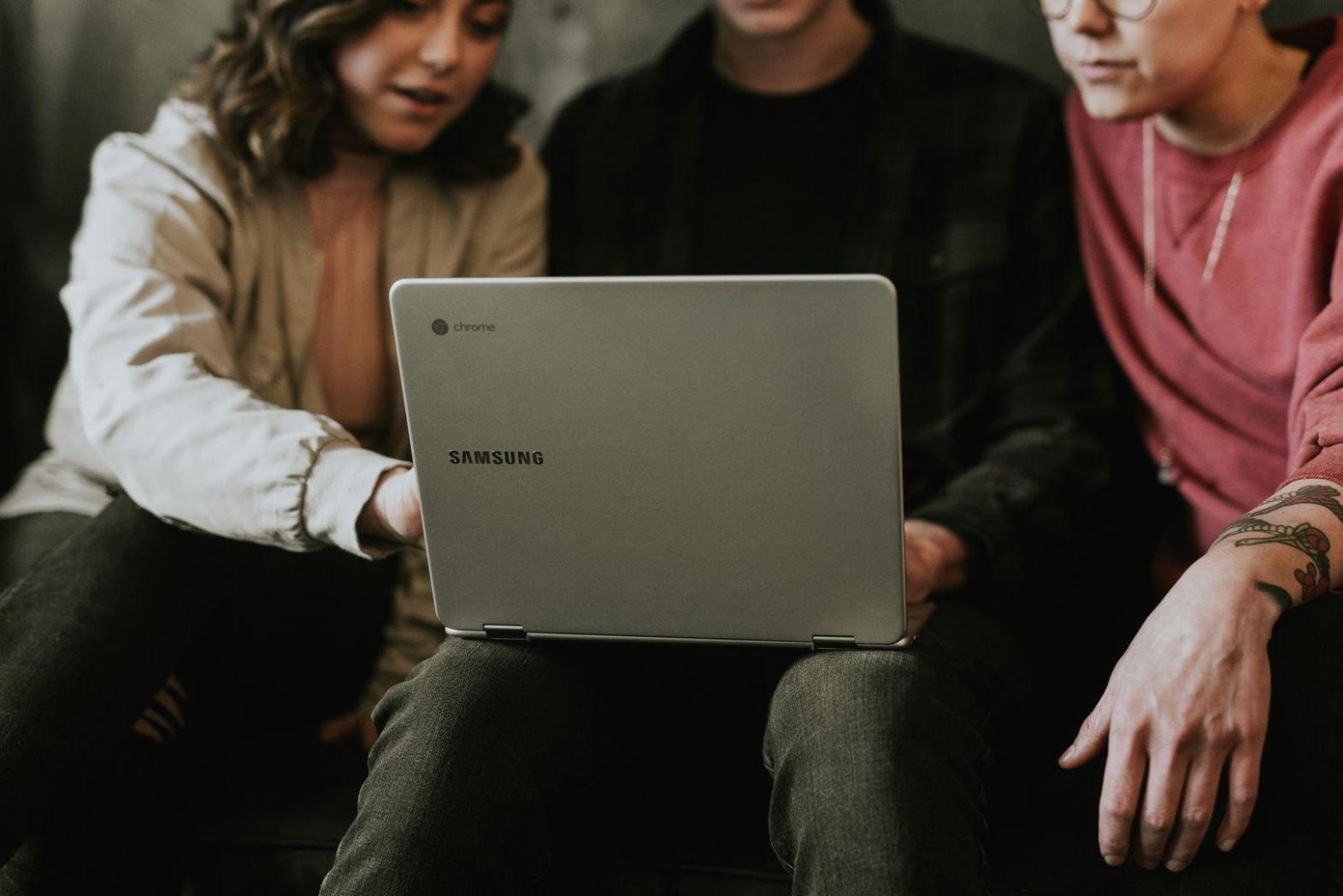Students analyzing banking security protocols on computer screens in a modern learning environment